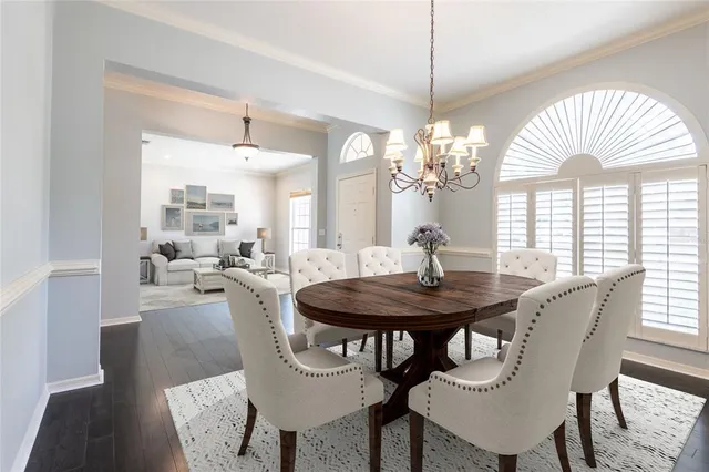a view of a dining room with furniture and a chandelier
