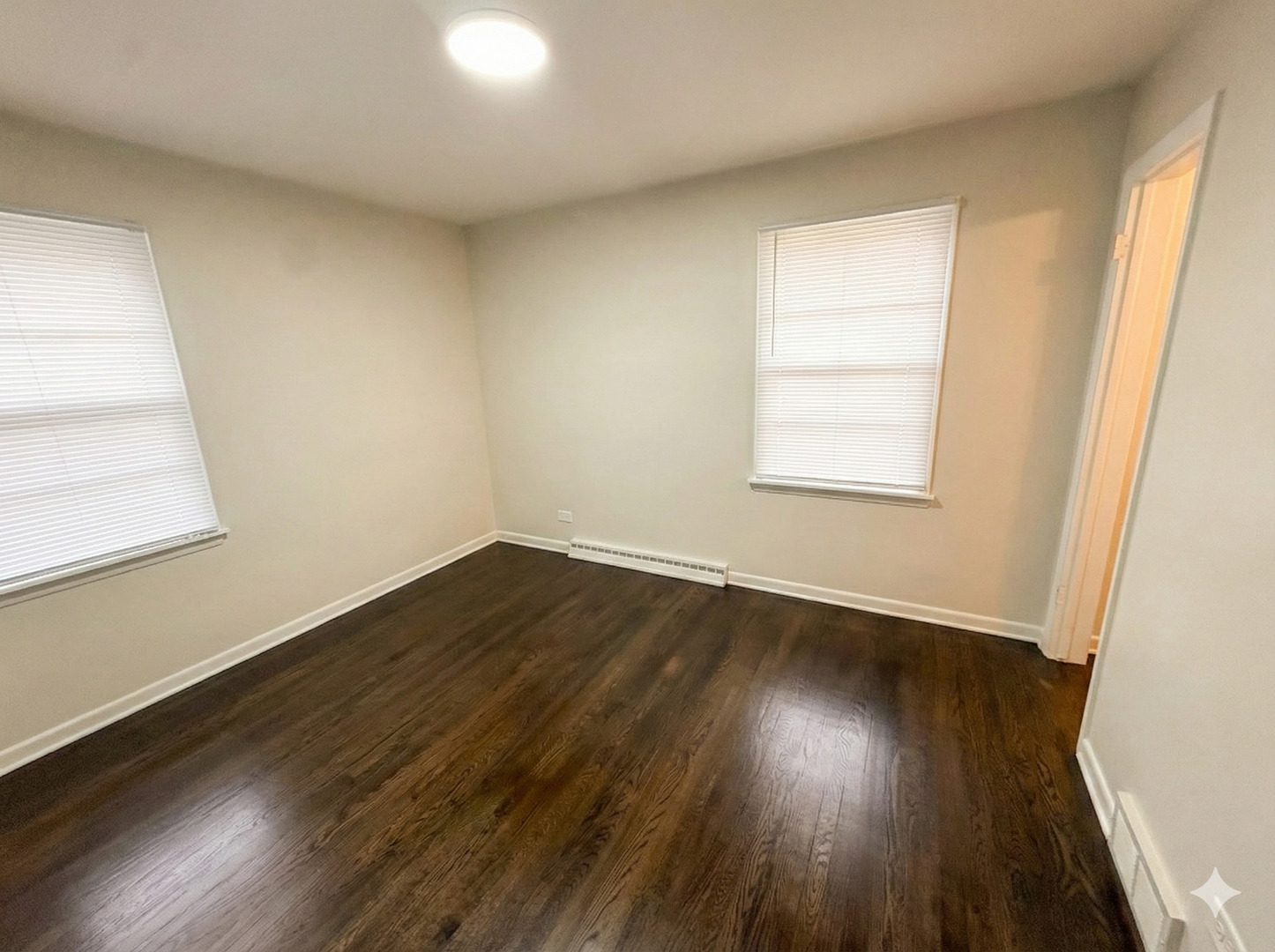 37684 North Sheridan Road Beach Park, IL 60087 - Photo 14 of 27 an empty room with wooden floor and windows