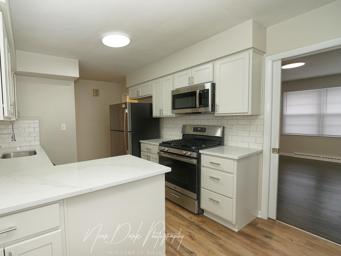 37684 North Sheridan Road Beach Park, IL 60087 - Photo 7 of 27 a kitchen with stainless steel appliances a stove microwave and refrigerator
