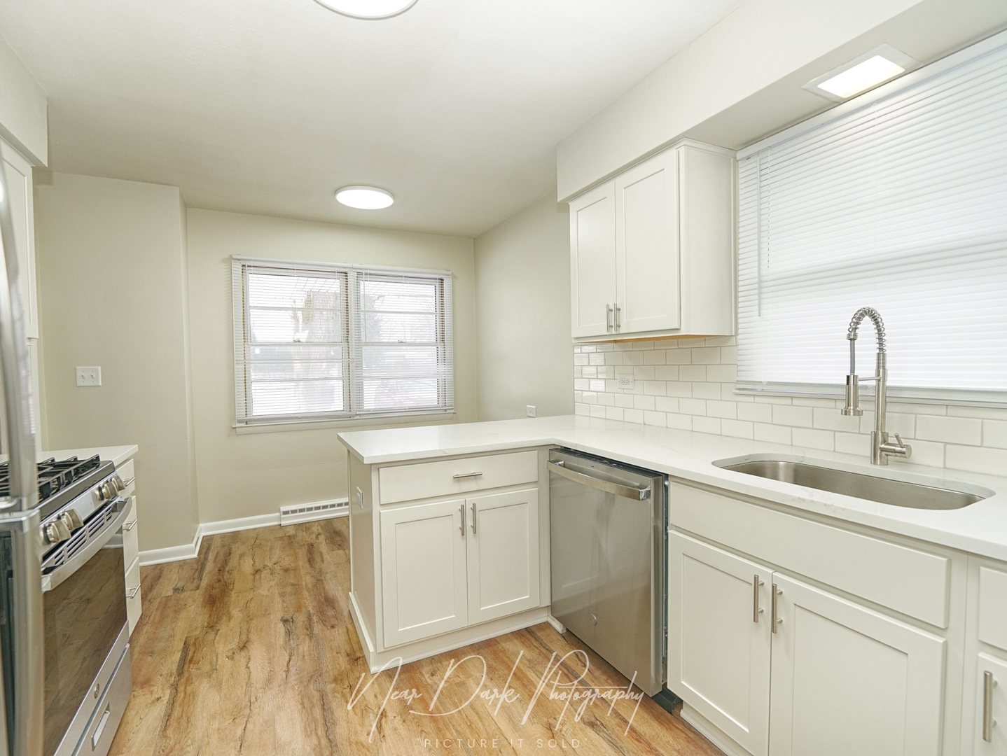 37684 North Sheridan Road Beach Park, IL 60087 - Photo 8 of 27 a kitchen with a sink stove and cabinets