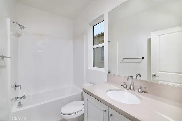a bathroom with a granite countertop sink toilet tub and shower