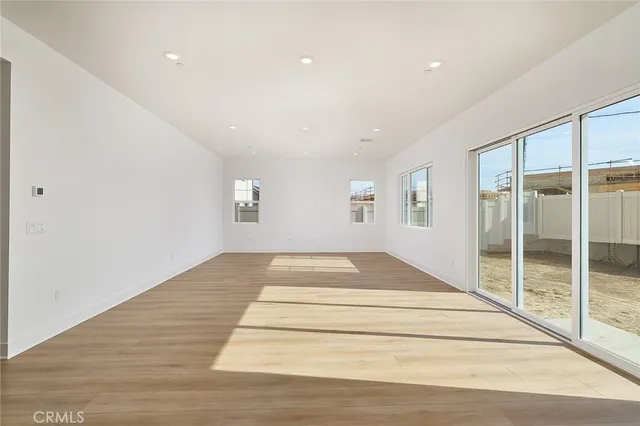 a spacious bedroom with a large bed and a chandelier