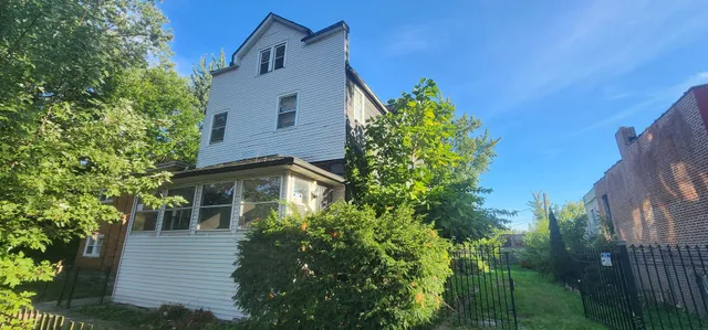front view of a house with a tree