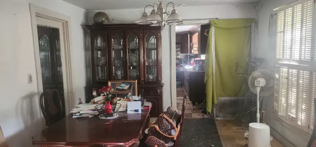 a room with lots of wooden furniture and windows