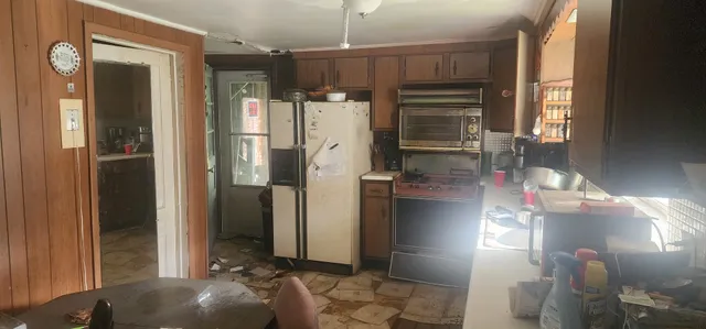 a kitchen with refrigerator and cabinets