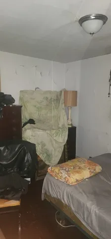 a bedroom with a bed and a night stand