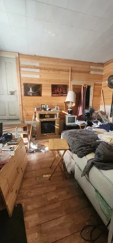 a living room with dining room and wooden floor