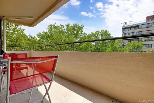 a view of yard from deck with patio