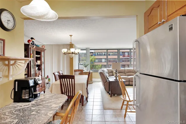 a view of a dining room with furniture and a chandelier