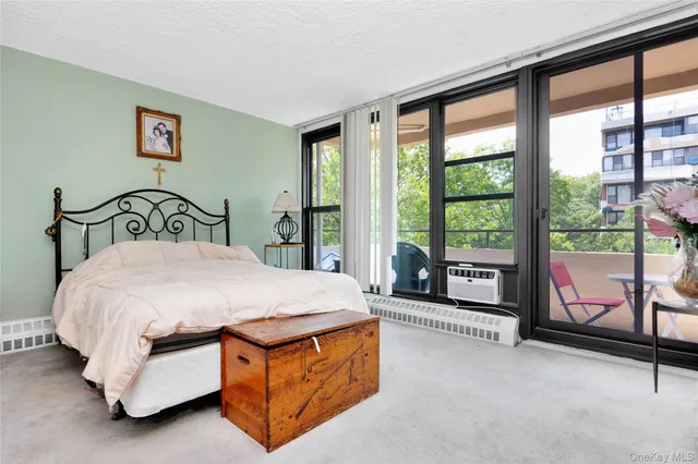 a bedroom with a bed and glass window