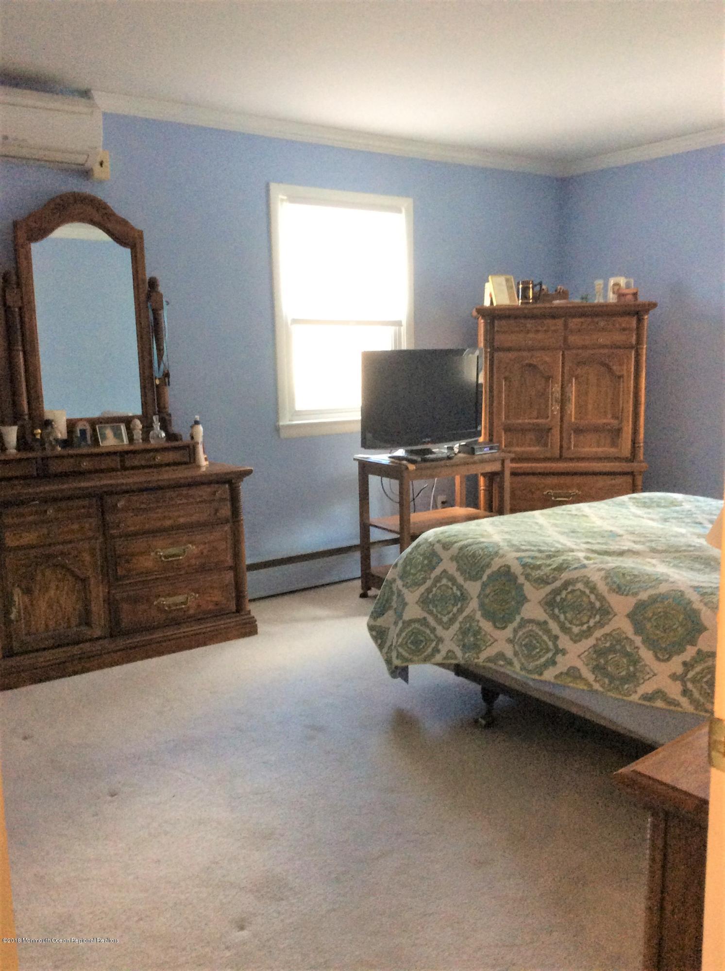 224 Old Mill Road Freehold, NJ 07728 - Photo 14 of 25 a bedroom with a bed and furniture
