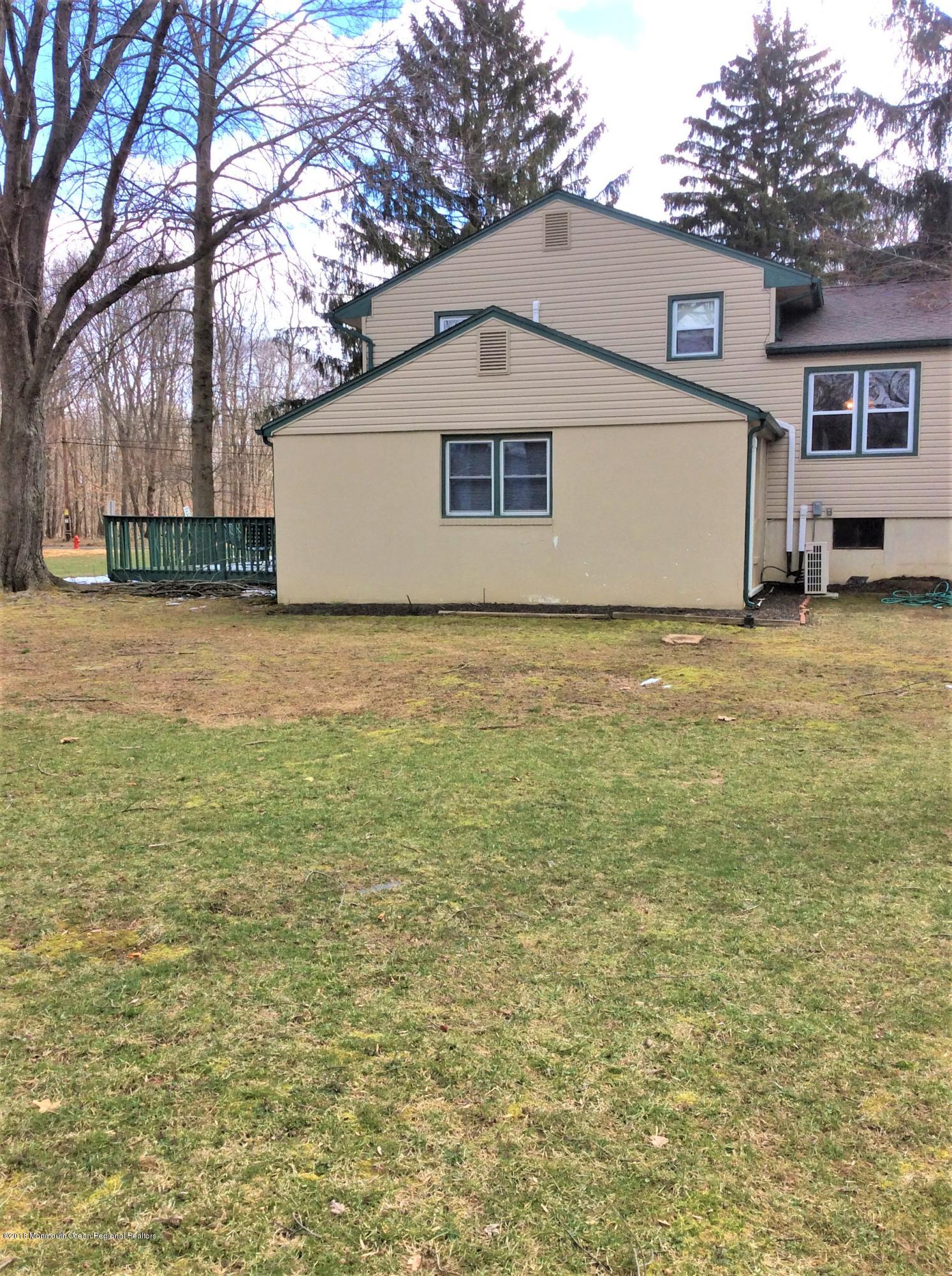 224 Old Mill Road Freehold, NJ 07728 - Photo 23 of 25 a view of a yard in front of a house with a large tree
