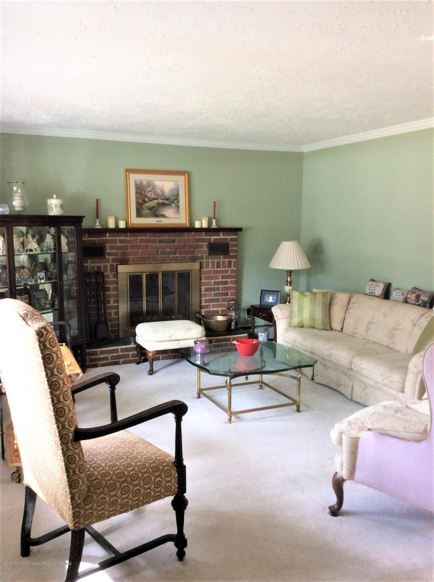 224 Old Mill Road Freehold, NJ 07728 - Photo 7 of 25 a living room with furniture and a lamp