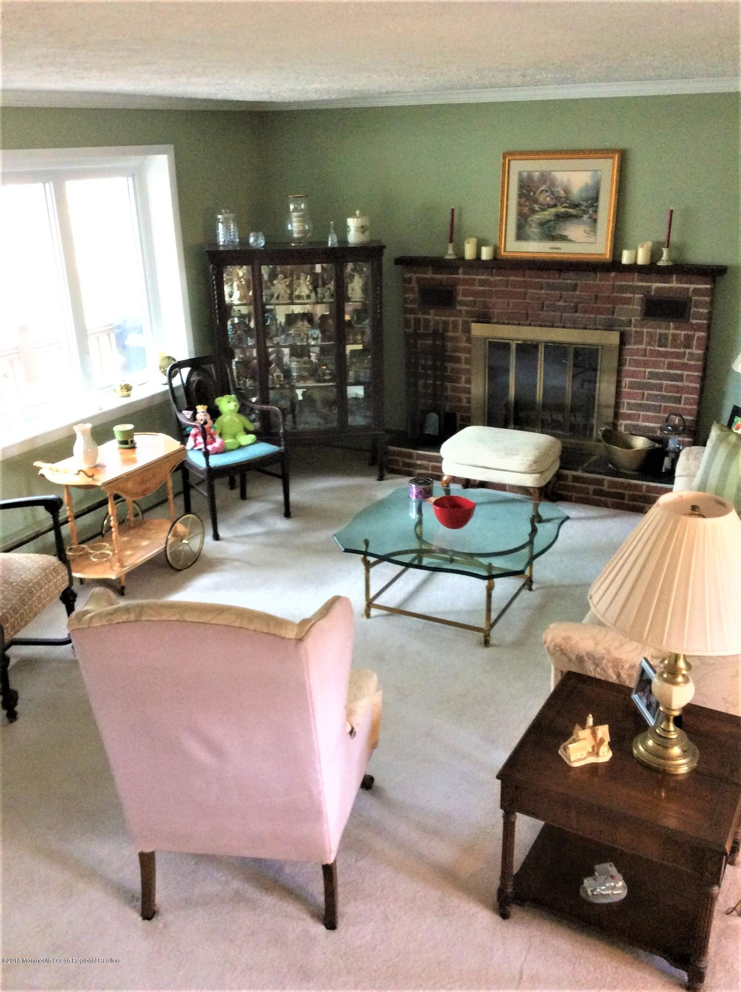 224 Old Mill Road Freehold, NJ 07728 - Photo 8 of 25 a living room with furniture a rug and a large window