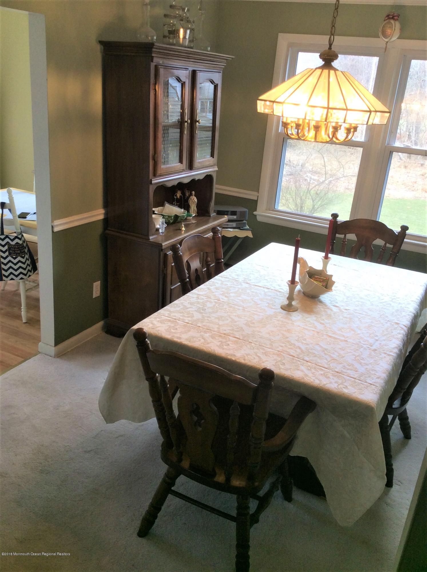 224 Old Mill Road Freehold, NJ 07728 - Photo 10 of 25 a dining table with chairs and window