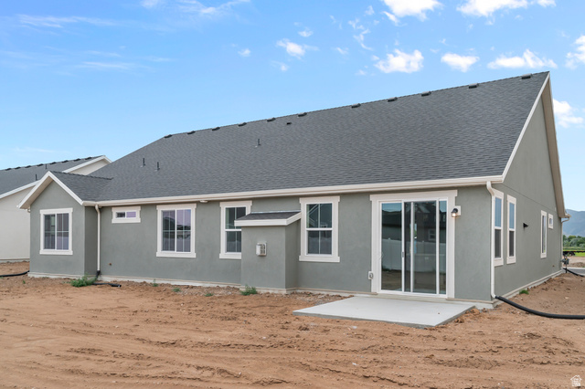 1869 South 2425 West Ogden, UT 84401 - Photo 4 of 22 Back of house featuring a patio, a shingled roof, and stucco siding