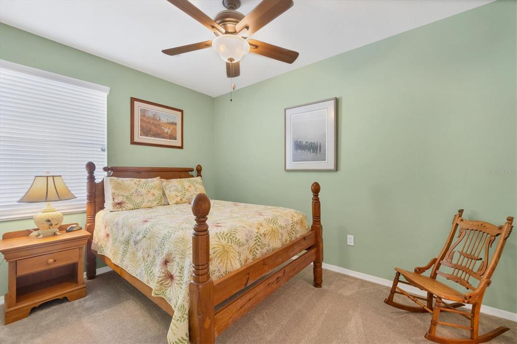 9203 Griggs Road, Unit A302 Englewood, FL 34224 - Photo 25 of 42 a bedroom with a bed and a chandelier