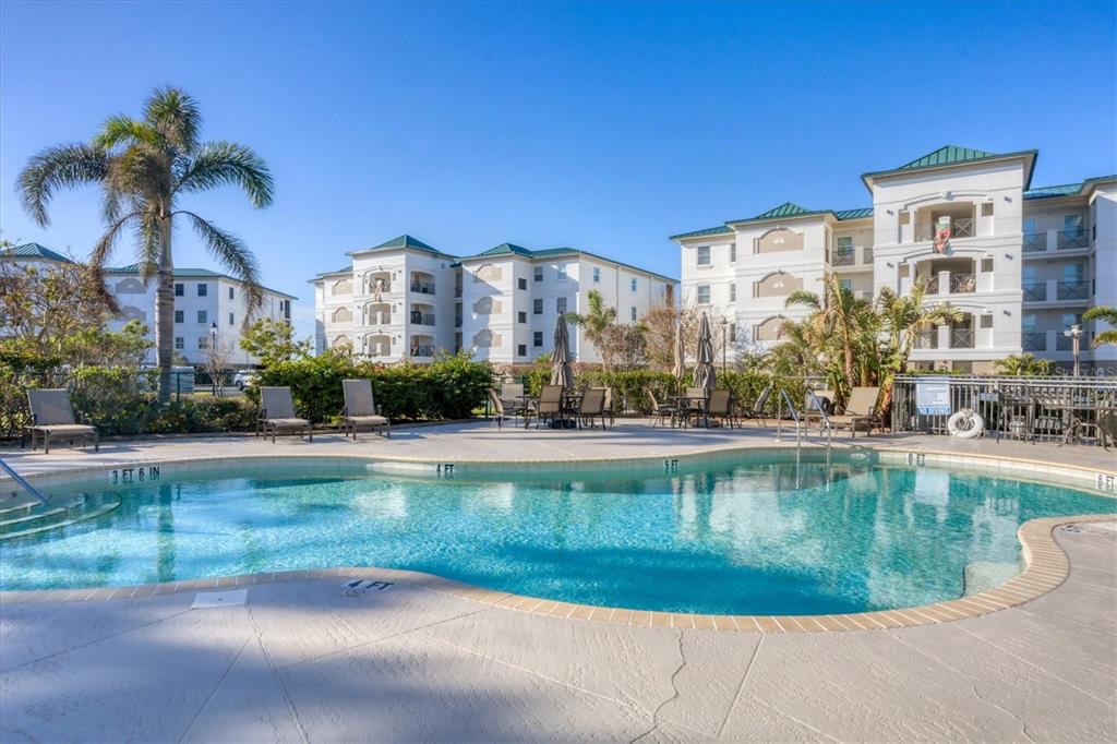 9203 Griggs Road, Unit A302 Englewood, FL 34224 - Photo 33 of 42 a view of a house with a swimming pool