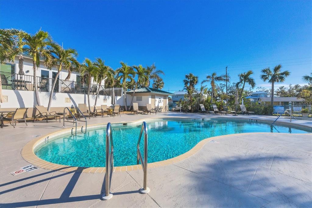 9203 Griggs Road, Unit A302 Englewood, FL 34224 - Photo 34 of 42 a swimming pool with outdoor seating and yard