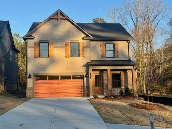 a front view of a house with garage