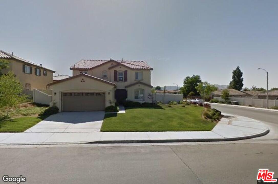 1401 Wild Olive Road Tehachapi, CA 93561 - Photo 2 of 7 a front view of a house with a yard and garage