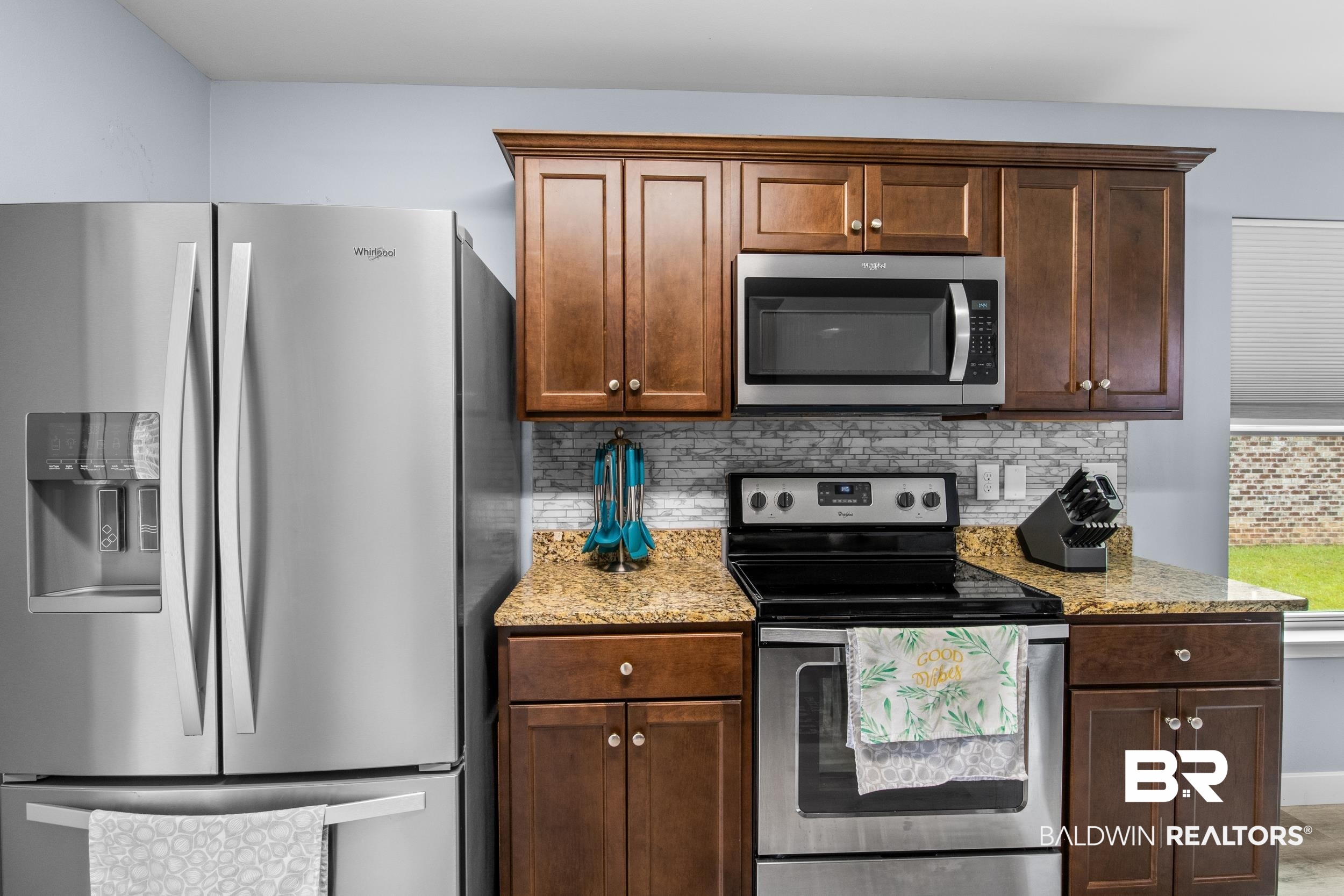 3852 Chesterfield Lane Foley, AL 36535 - Photo 18 of 34 Kitchen with stainless steel appliances, light stone countertops, and decorative backsplash
