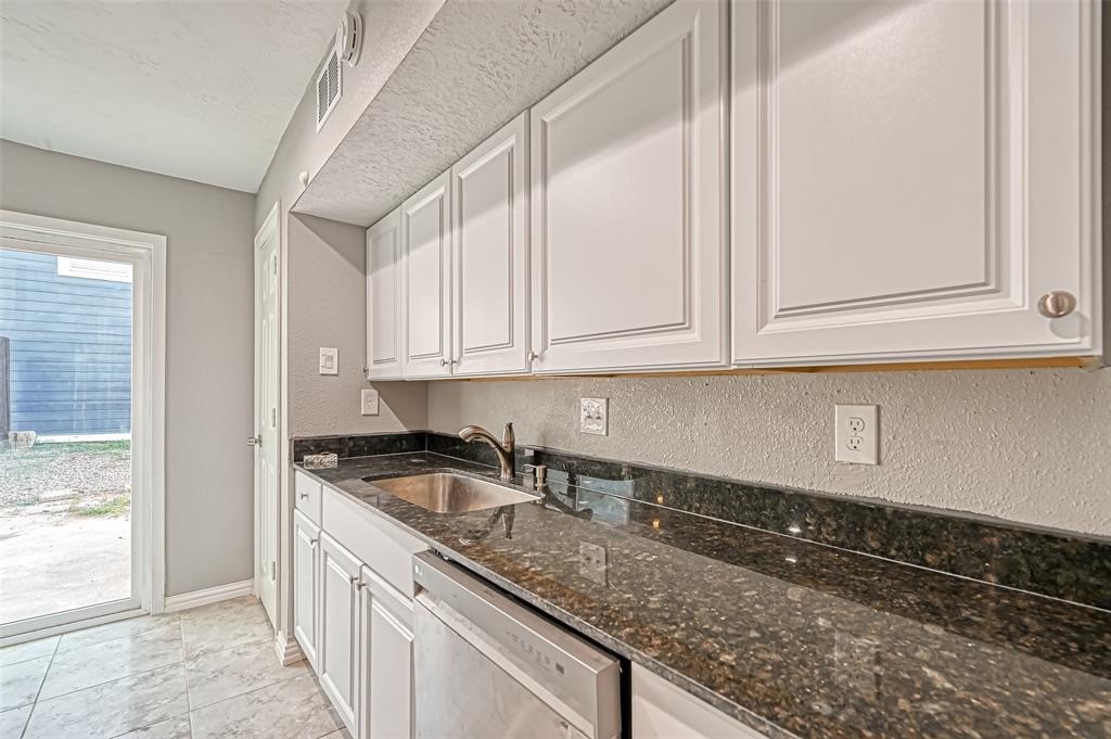 10252 Cottage Field Road Houston, TX 77041 - Photo 11 of 18 a kitchen with granite countertop white cabinets and a sink