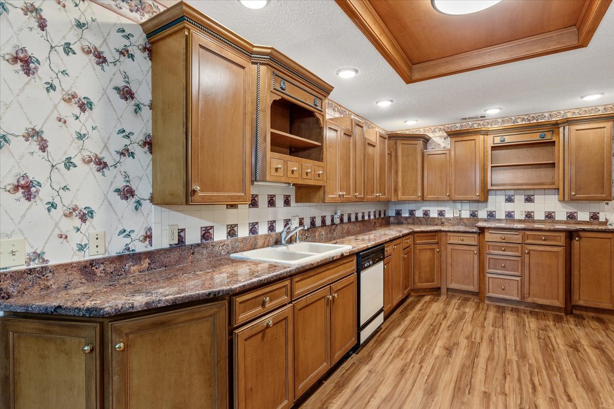 250 Hickory Drive Elgin, TX 78621 - Photo 11 of 37 a kitchen with stainless steel appliances granite countertop a sink and cabinets