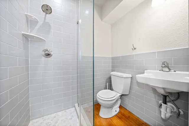 a bathroom with a toilet a sink and shower