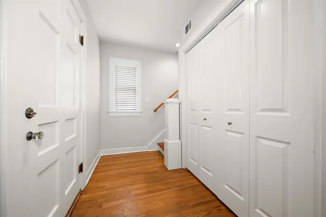 a view of entryway and hall with wooden floor
