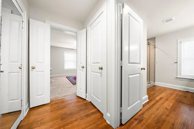 a bedroom with a bed a window and a chandelier