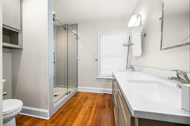 a bathroom with a granite countertop sink mirror and double