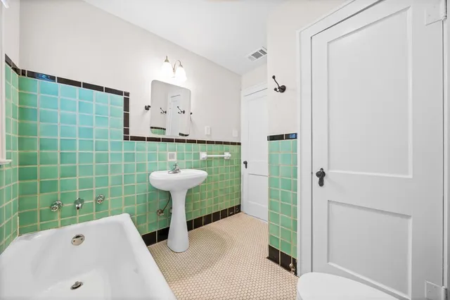 a bathroom with a toilet and a sink