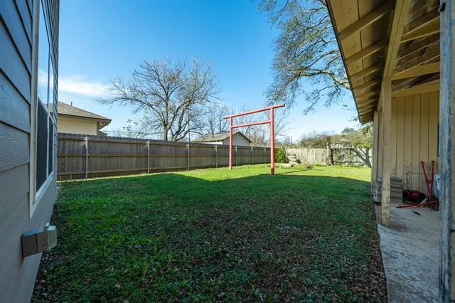 a backyard of a house with table and chairs