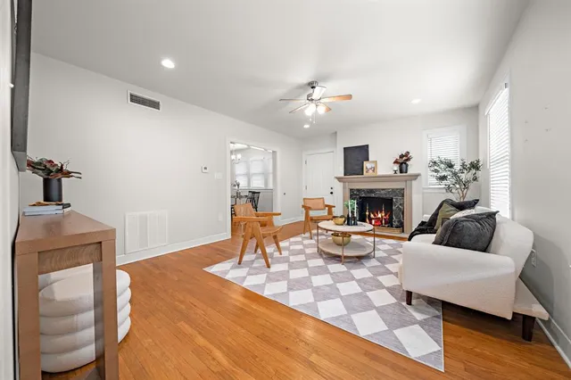 a living room with furniture a fireplace and a table