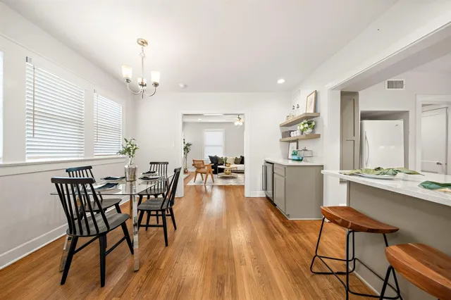 a view of a dining room with furniture and wooden floor