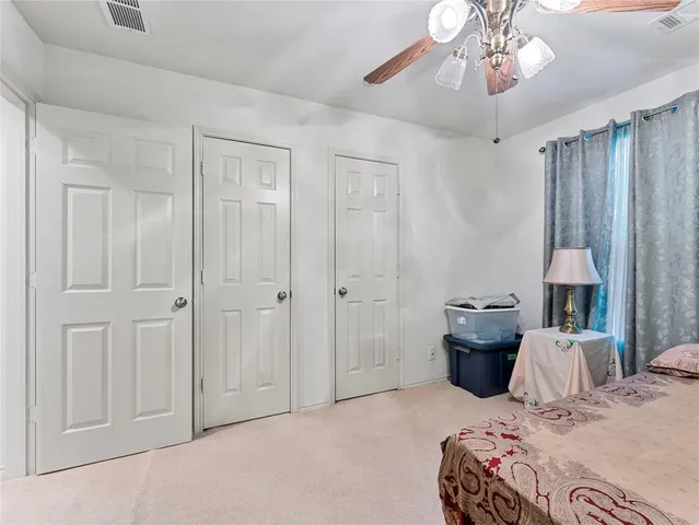 a bedroom with a bed and chandelier