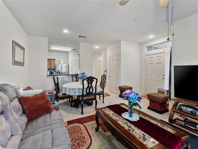 a kitchen with stainless steel appliances granite countertop a sink stove microwave and refrigerator