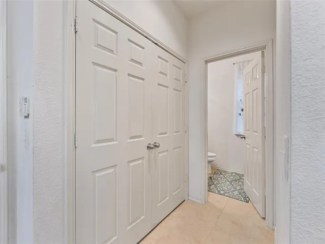a bathroom with a granite countertop sink a toilet and a mirror