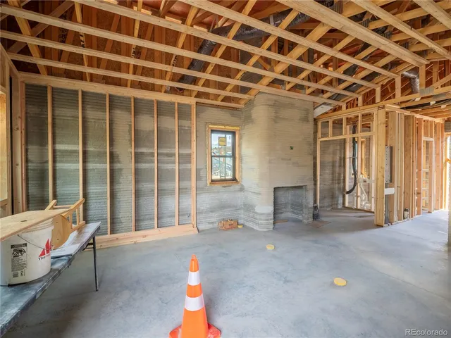 a view of a patio with table and chairs and a barbeque