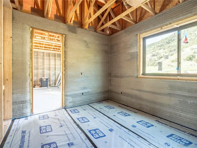 wooden floor in a bedroom next to a window