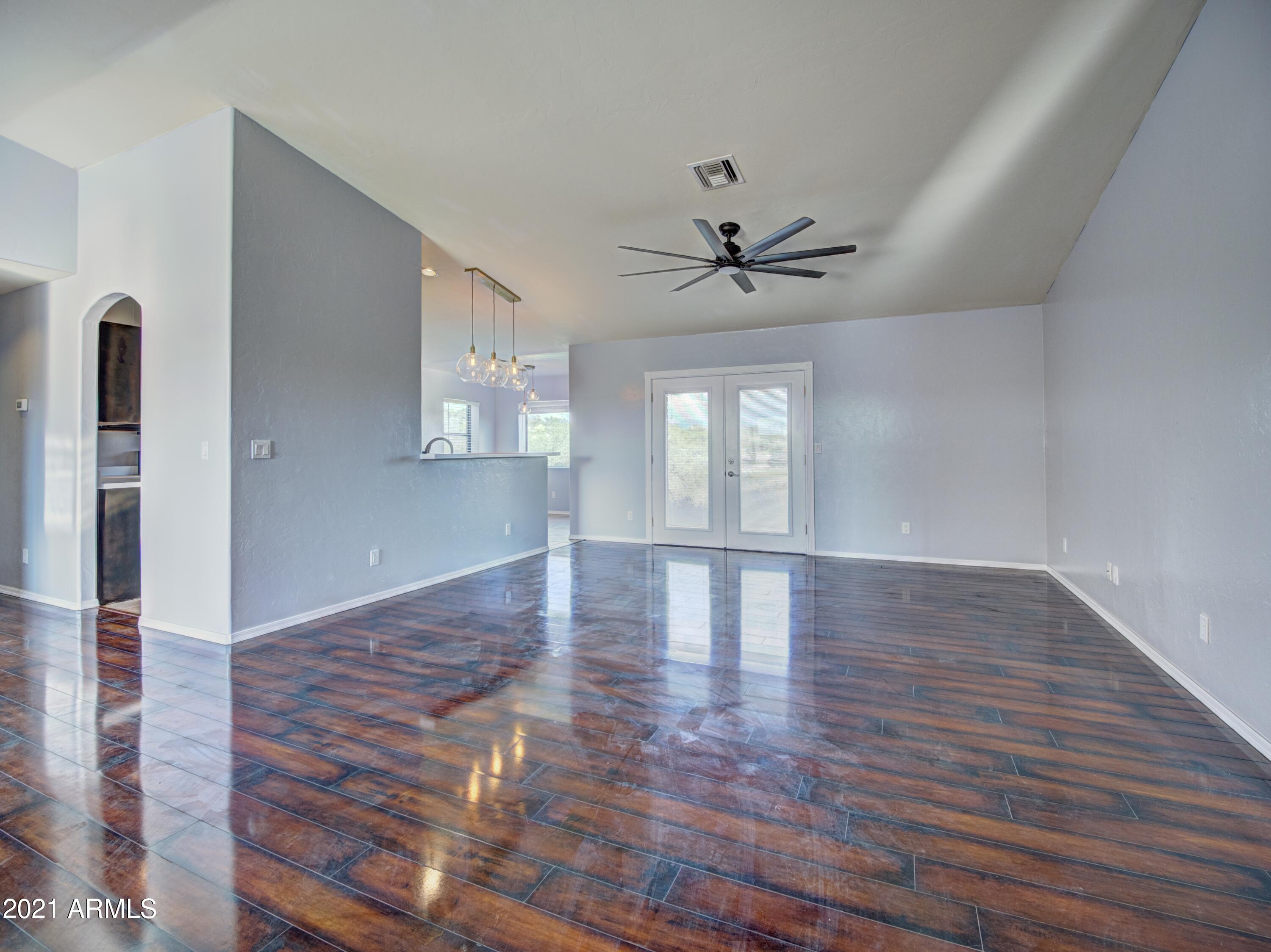 982 Circulo Tumbleweed Rio Rico, AZ 85648 - Photo 11 of 28 a view of an empty room with window and wooden floor