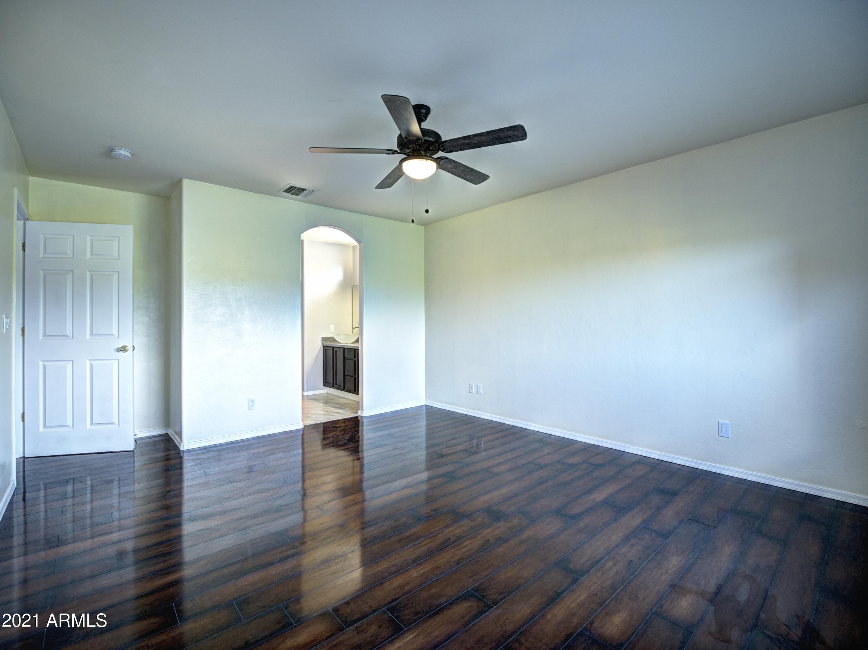 982 Circulo Tumbleweed Rio Rico, AZ 85648 - Photo 17 of 28 wooden floor in an empty room with a window