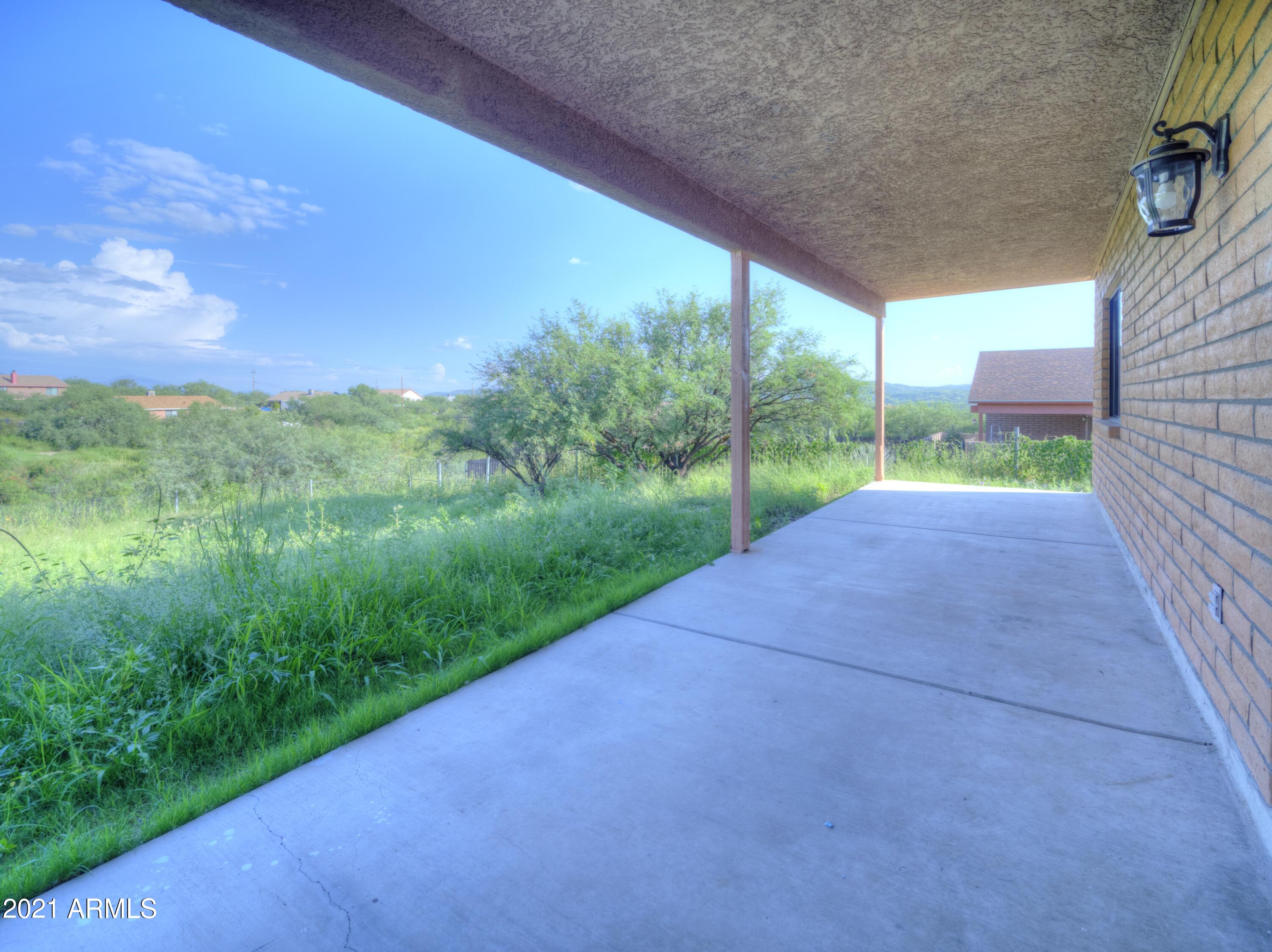 982 Circulo Tumbleweed Rio Rico, AZ 85648 - Photo 7 of 28 a view of a yard with porch