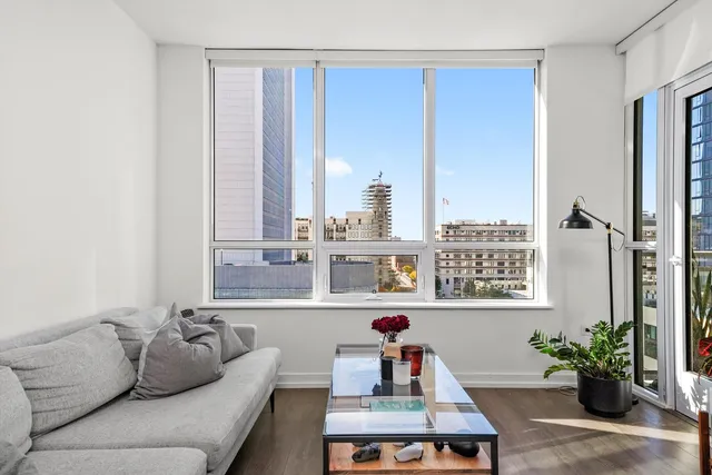 a living room with furniture and next to a window