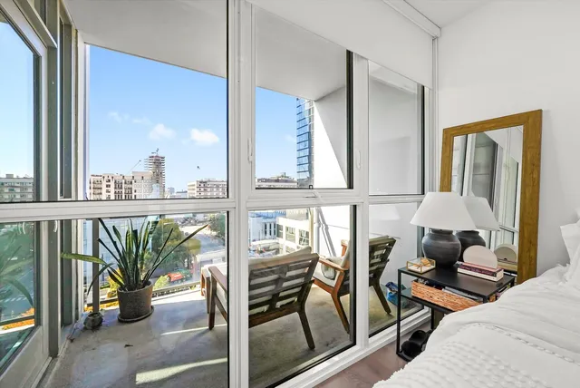 a view of a balcony with chairs and a potted plant