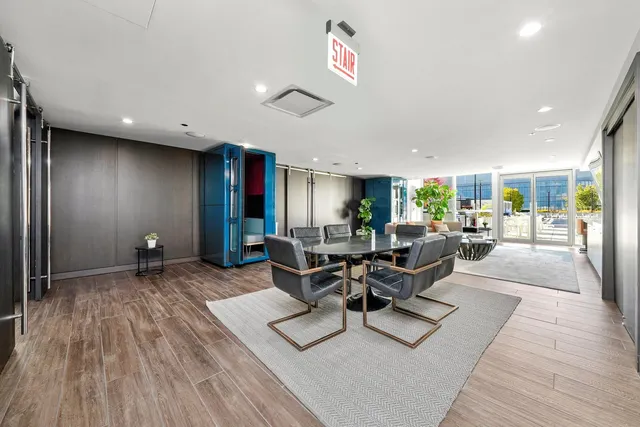 a living room with furniture a wooden floor and a large window