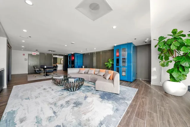 a living room with furniture and a potted plant