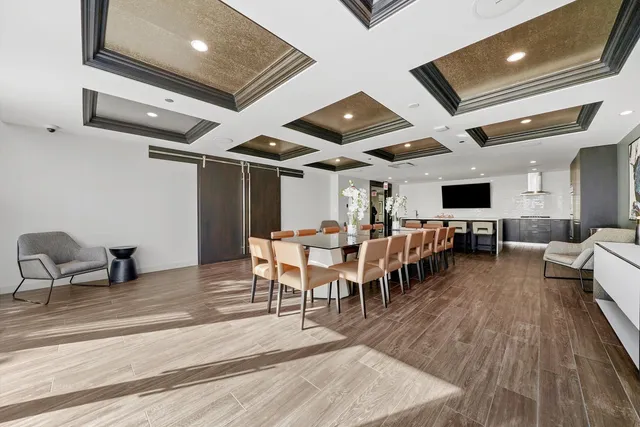 a living room with lots of furniture and kitchen view