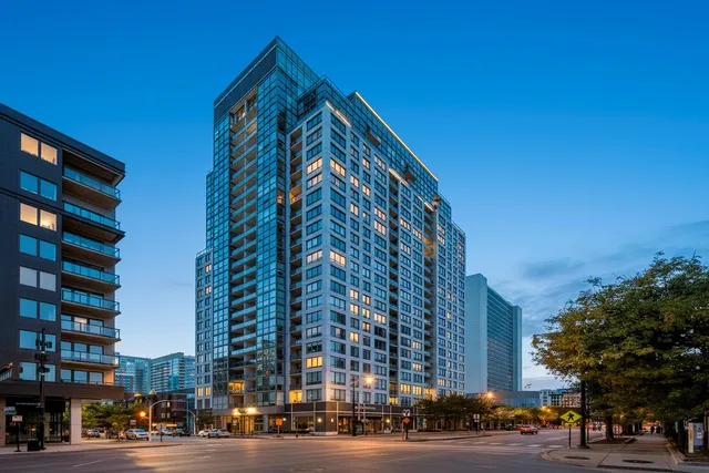 a view of a tall building next to a road